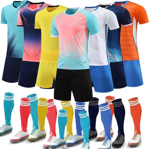 Plain football kits in many colours with matching socks laid out in a row