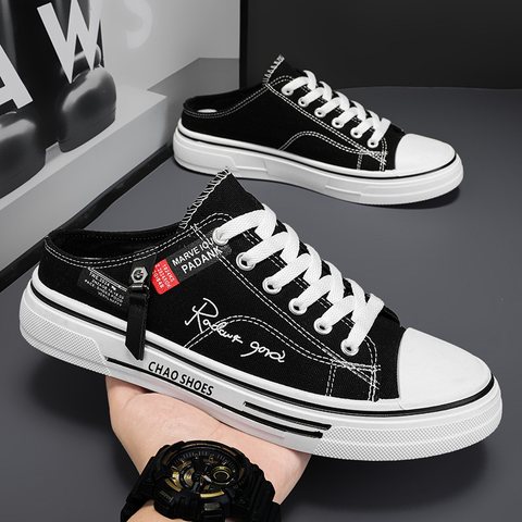 Black and white canvas sneakers with a fold-down heel