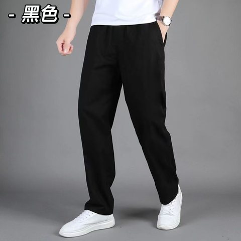 Model in black straight-leg cotton joggers and white sneakers